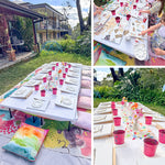 A three-panel collage showing an outdoor children's painting or craft activity setup. The left panel shows a long table set with paint palettes, small pink cups, and colorful pillows on a lawn in front of a house.